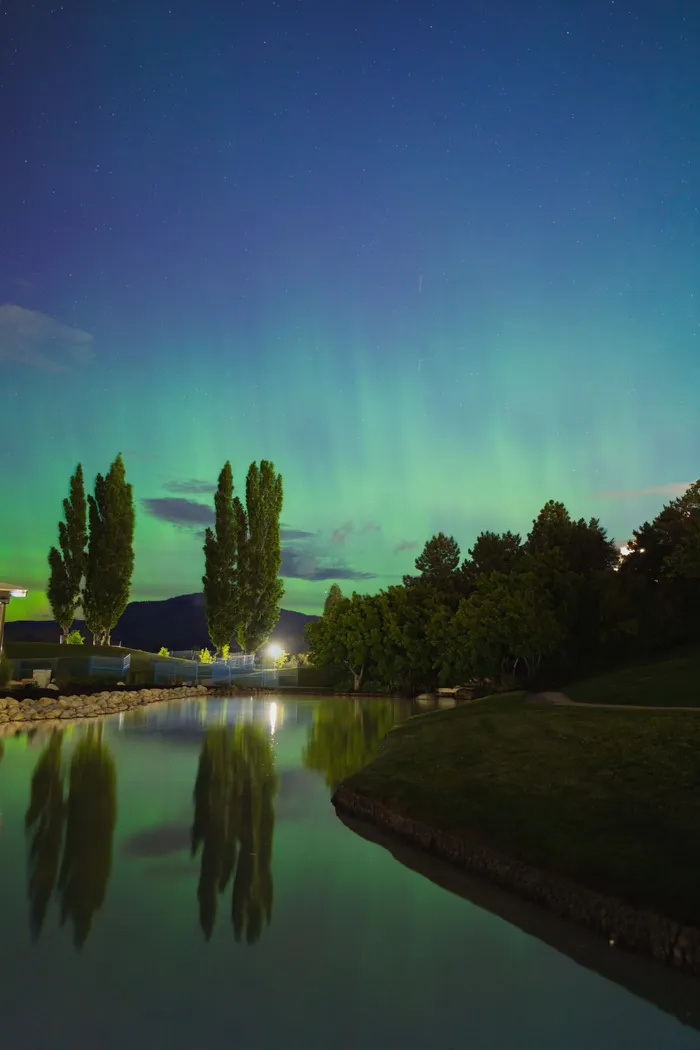 Aurora borealis over Kelowna BC mountains at night